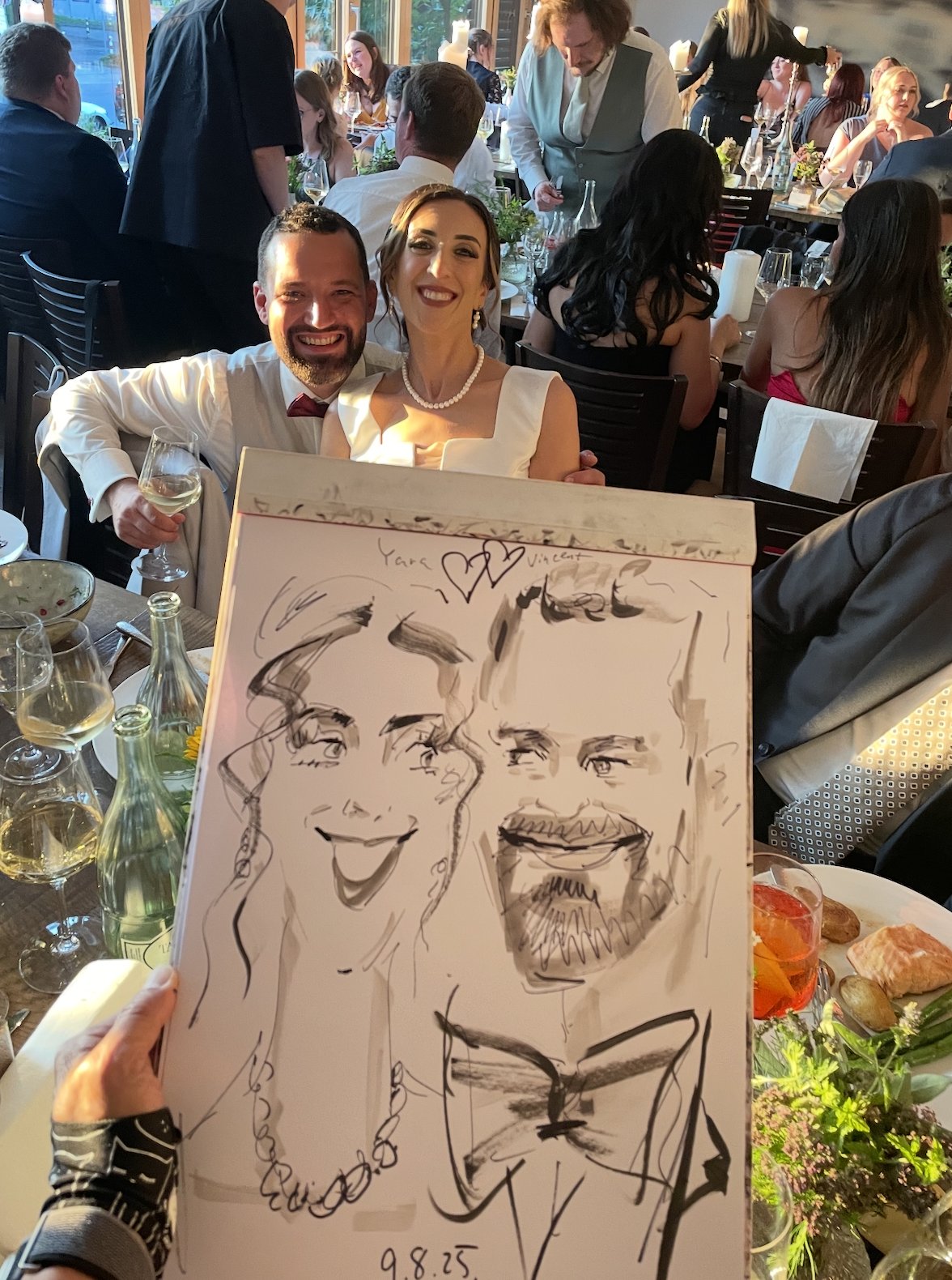 Guests with a quick sketch portrait at a wedding reception