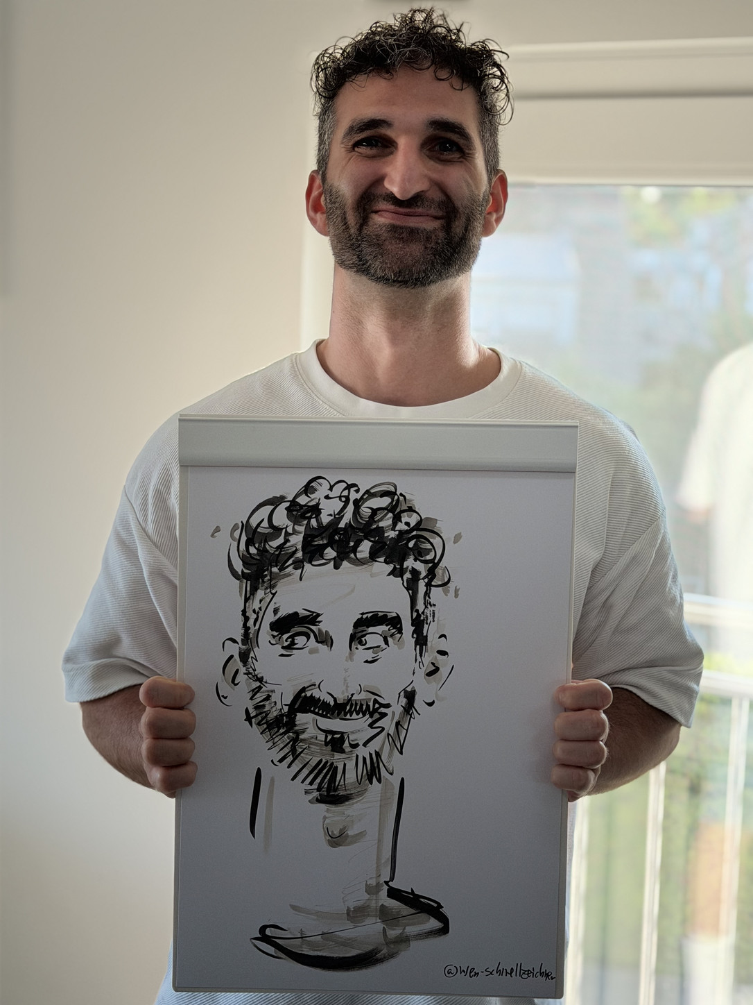 Man presenting his live-drawn caricature