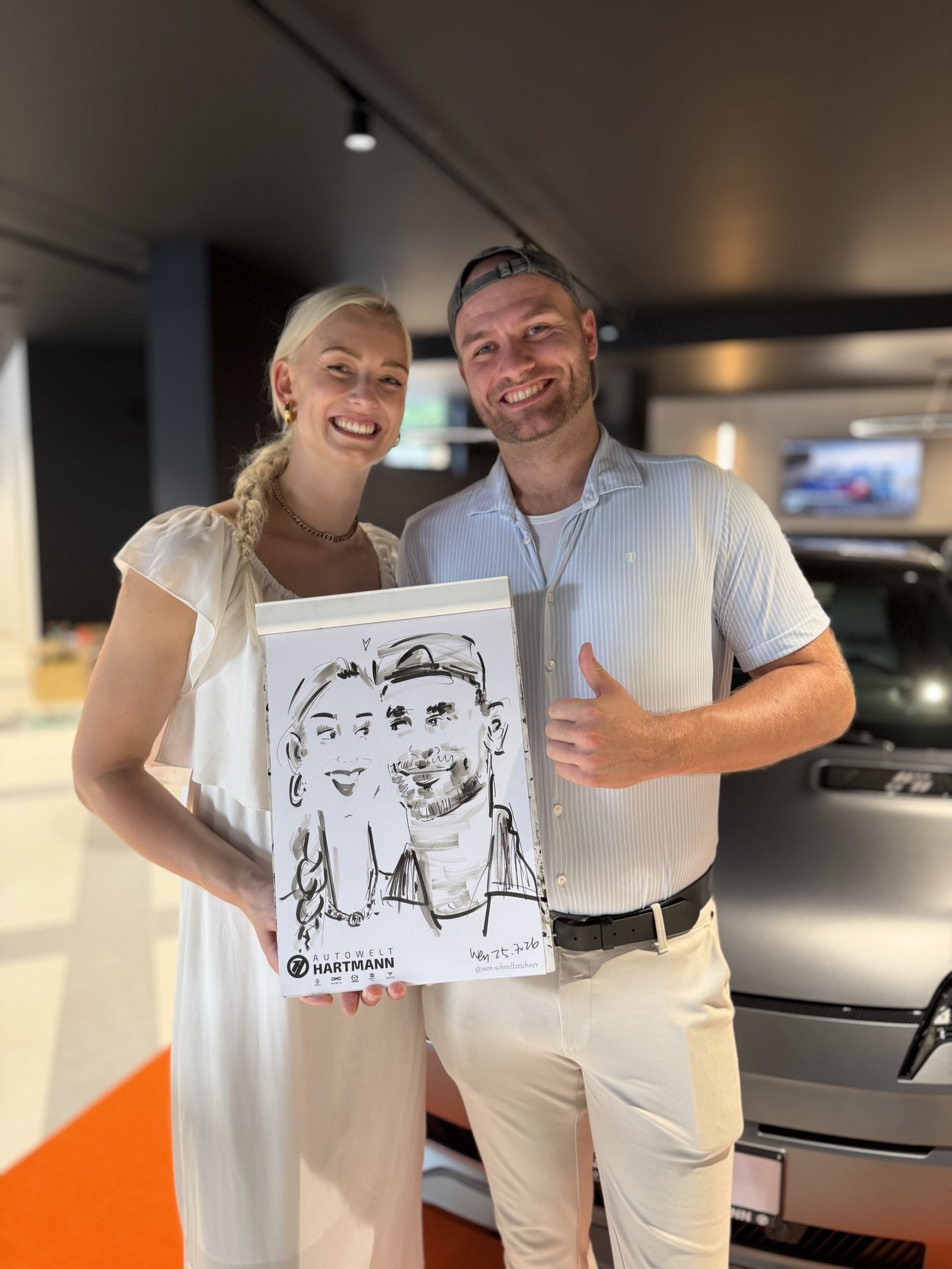 Couple presenting their live-drawn caricature
