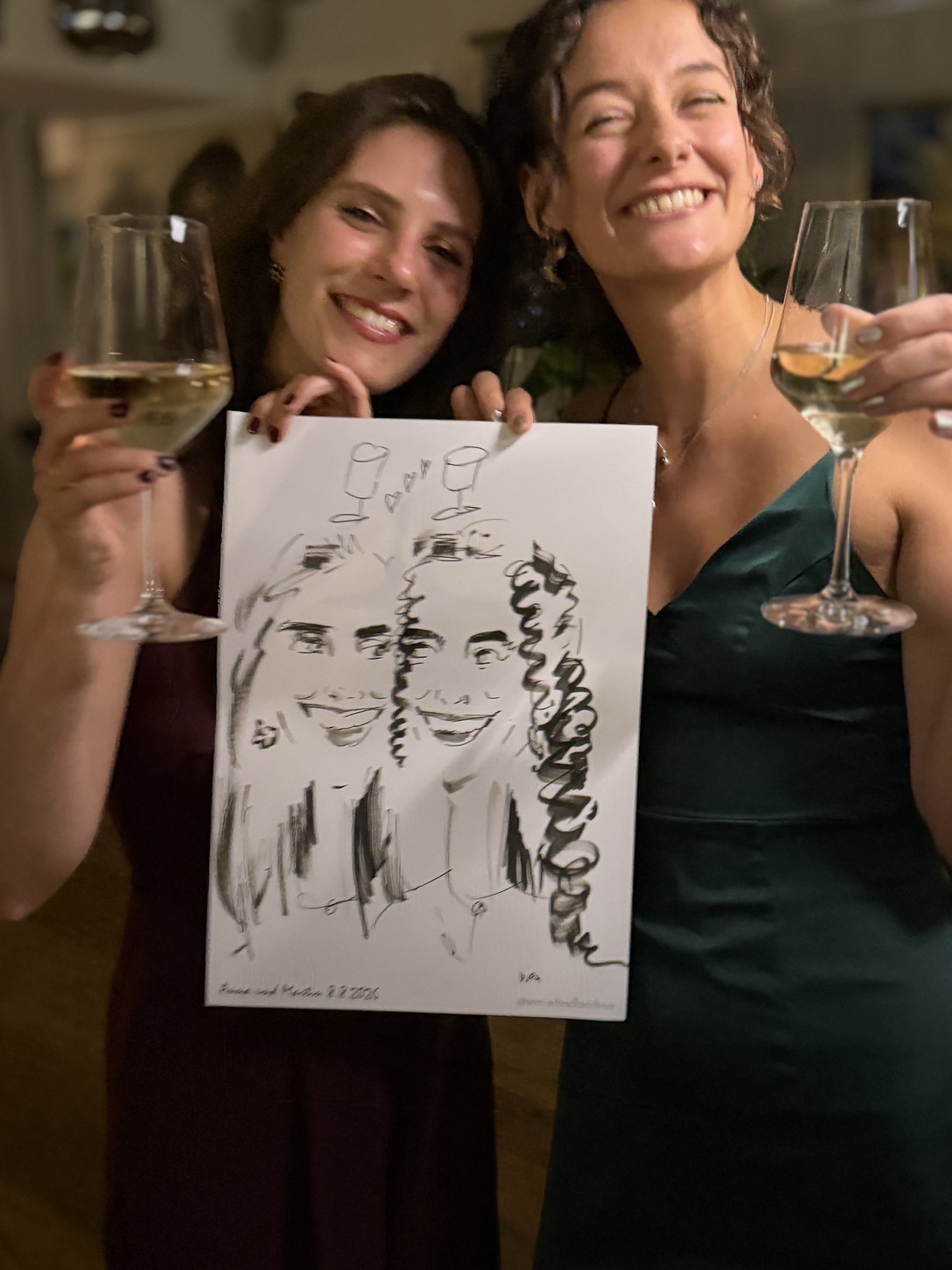 Two women celebrating with their live-drawn caricature